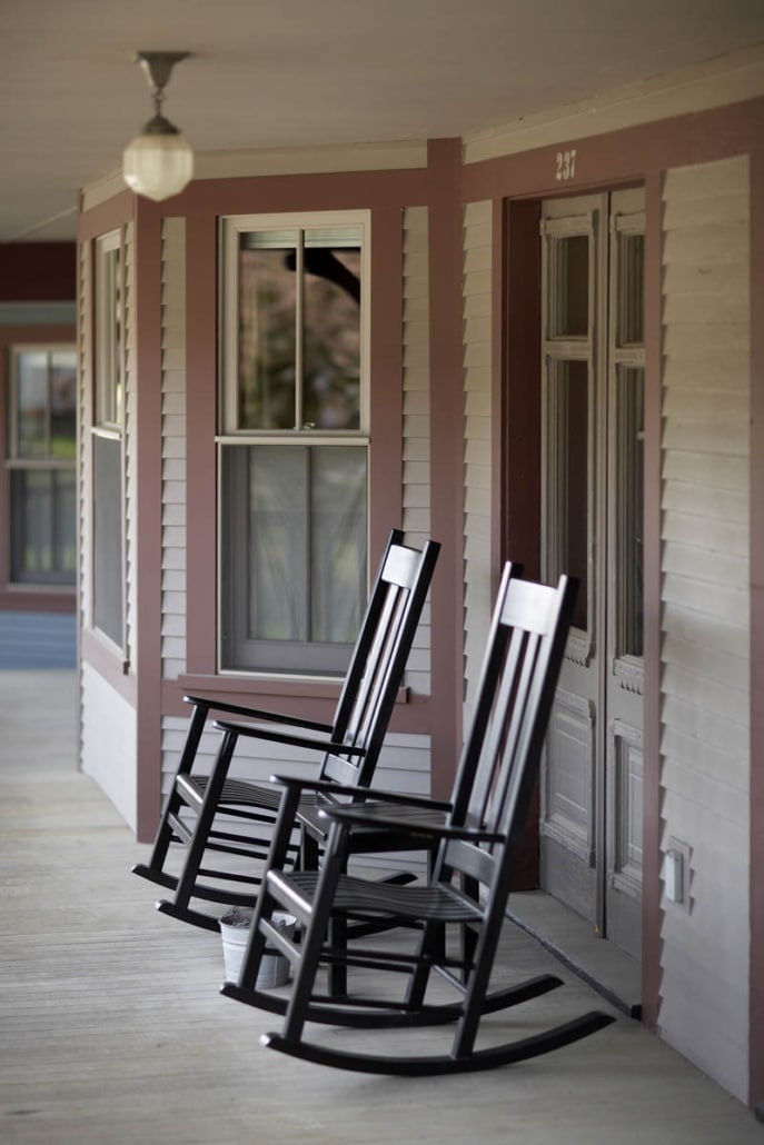 2 rocking chairs on a porch