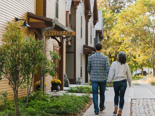 Couple walking outside exterior of Porches